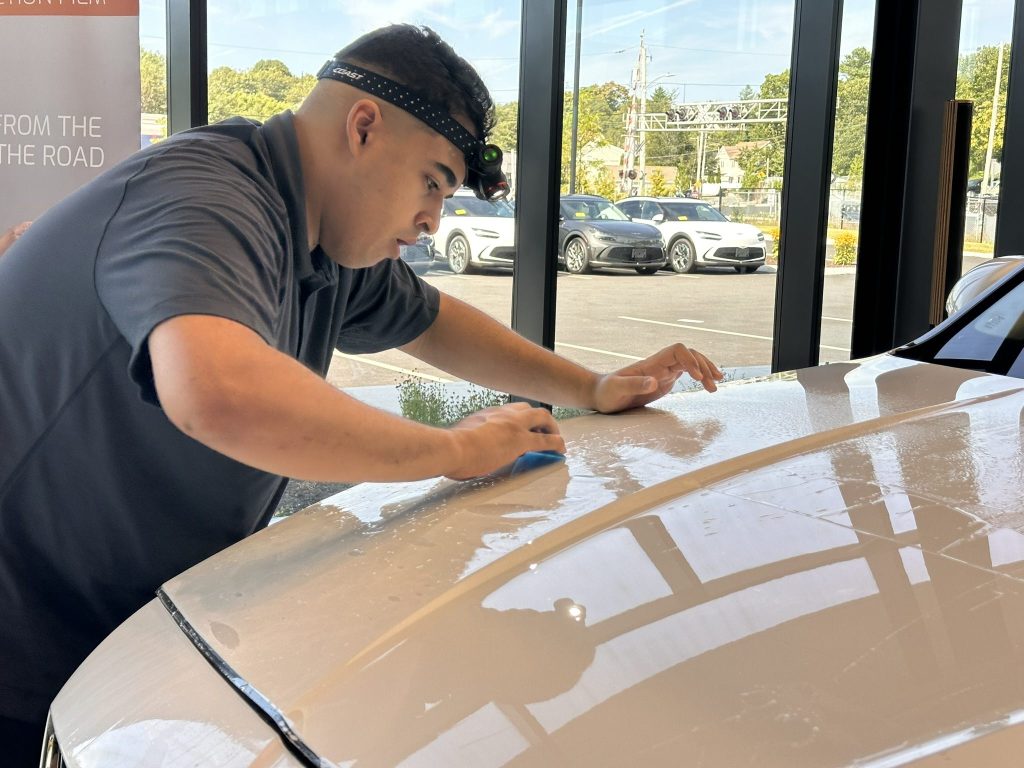 Technician installed PPF on hood of vehicle